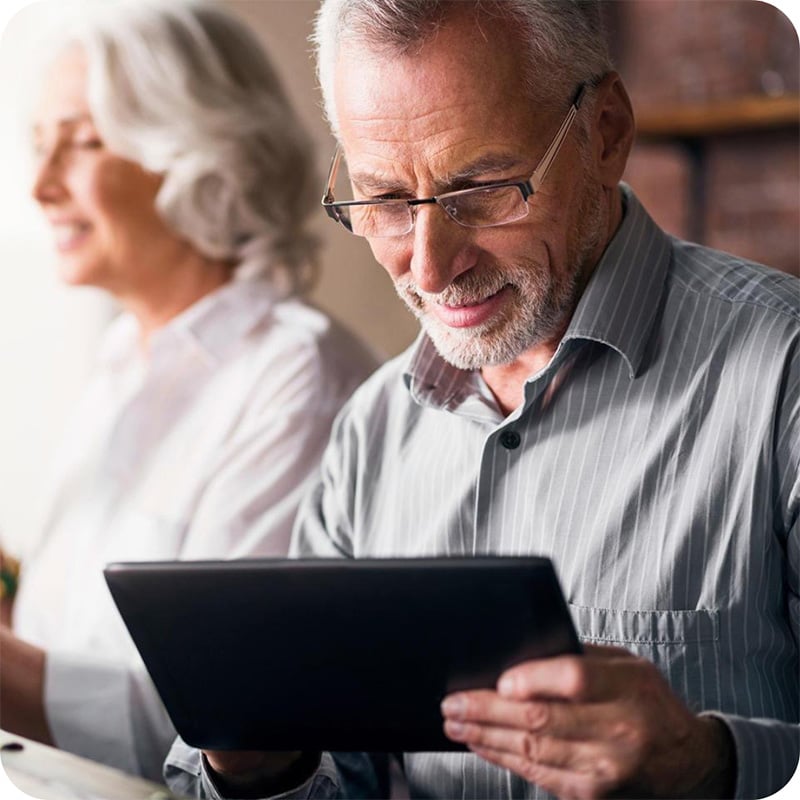 Older dentist using tablet
