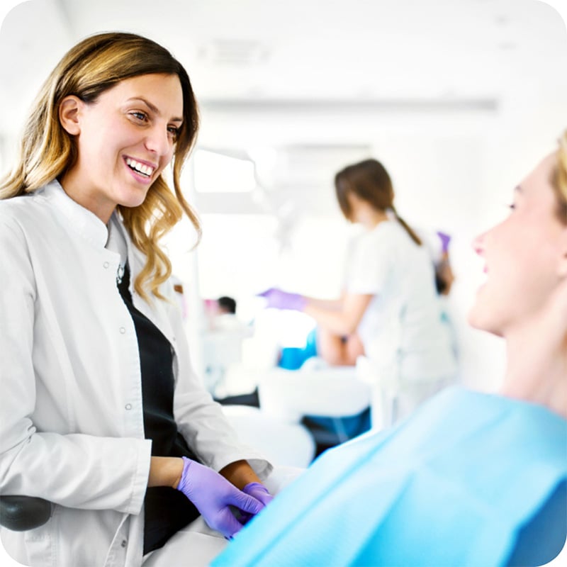 Dentist conversing with client