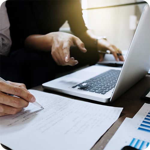 Two people at a laptop, appraising