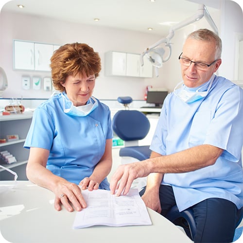 Doctors poring over a sales contract for their practice