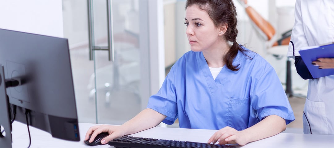 Doctor using a computer at a desk