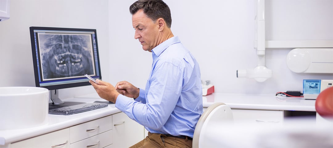 Dentist reviewing scanned mouth