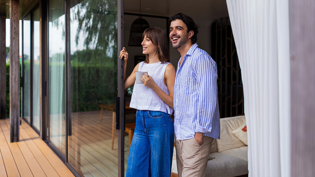 Couple looking out at a terrace at their rentvested home