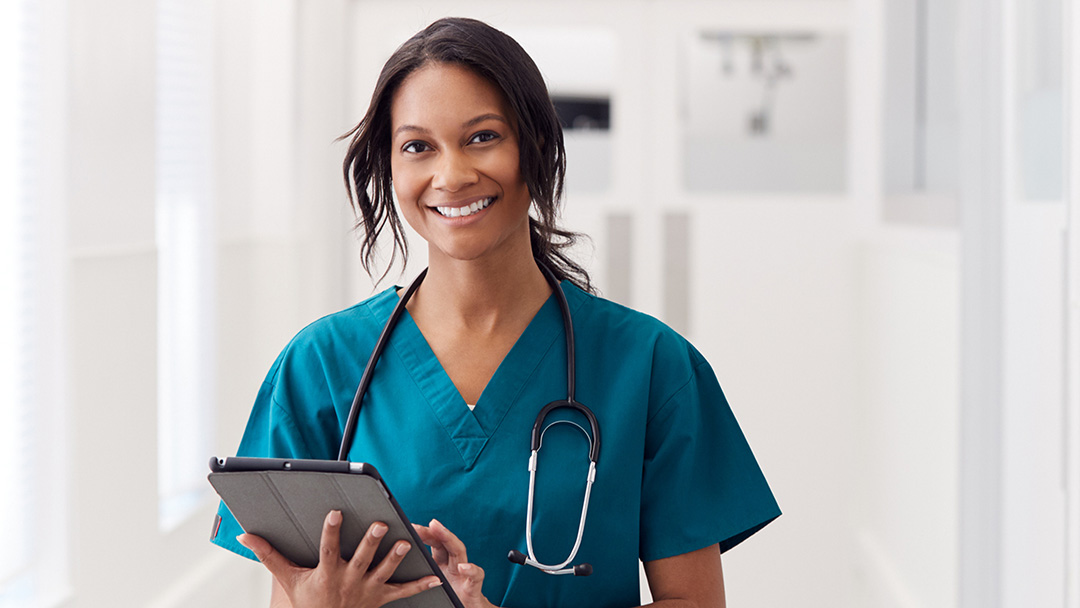 Doctor in corridor using-ipad