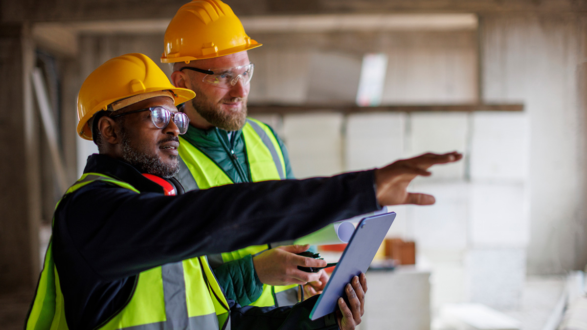 Workers planning using tablet on job site