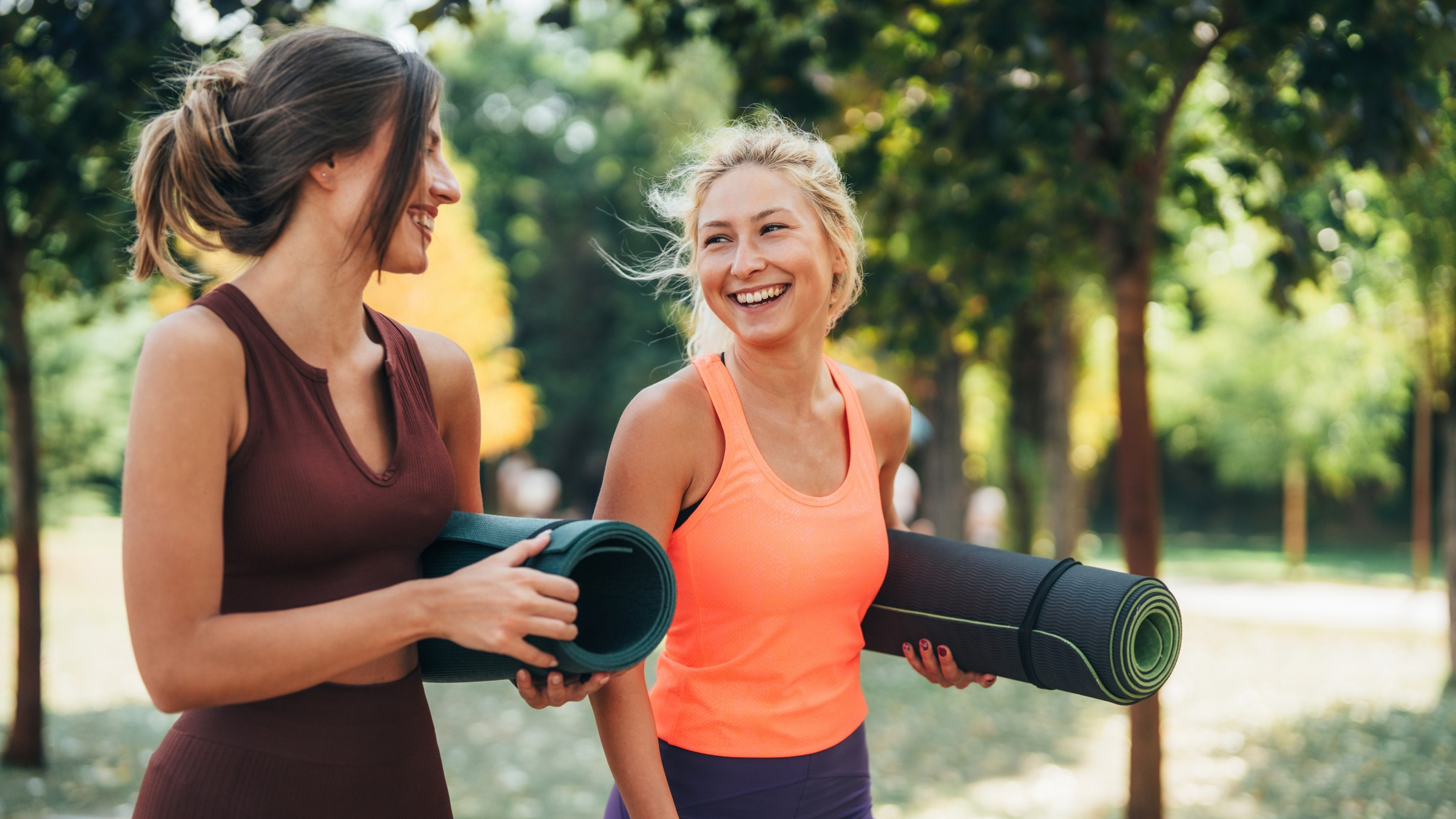 Two women with yoga mats