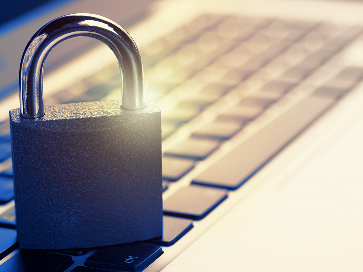 Padlock sitting on a computer keyboard, indicating privacy and security.