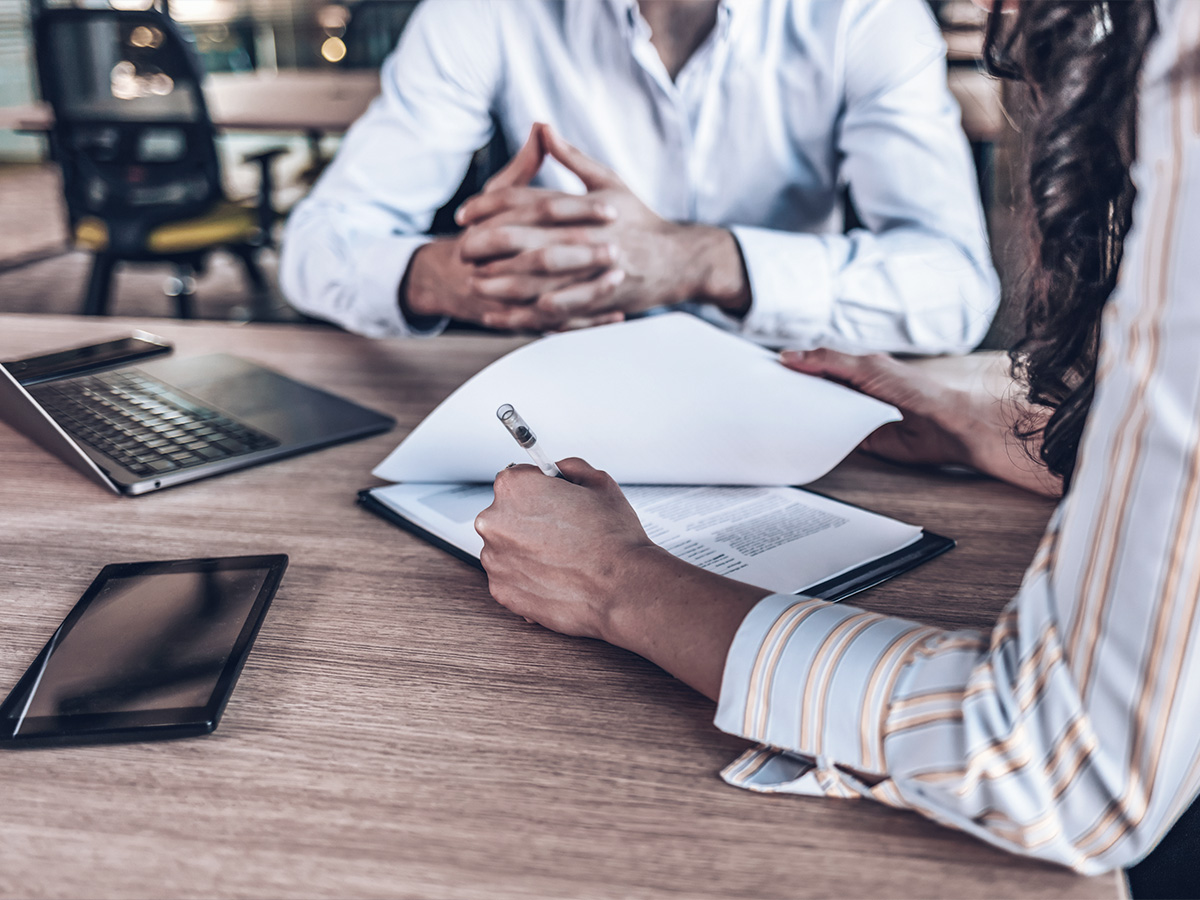 Businesspeople notating contract at desk