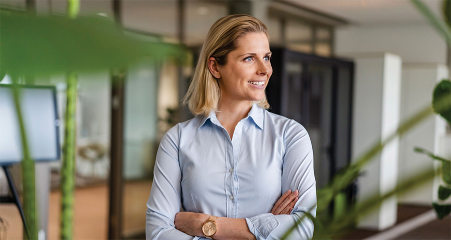 Smiling doctor in leafy practice