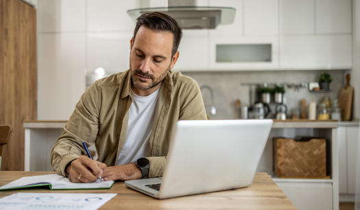 Man with laptop doing his taxes