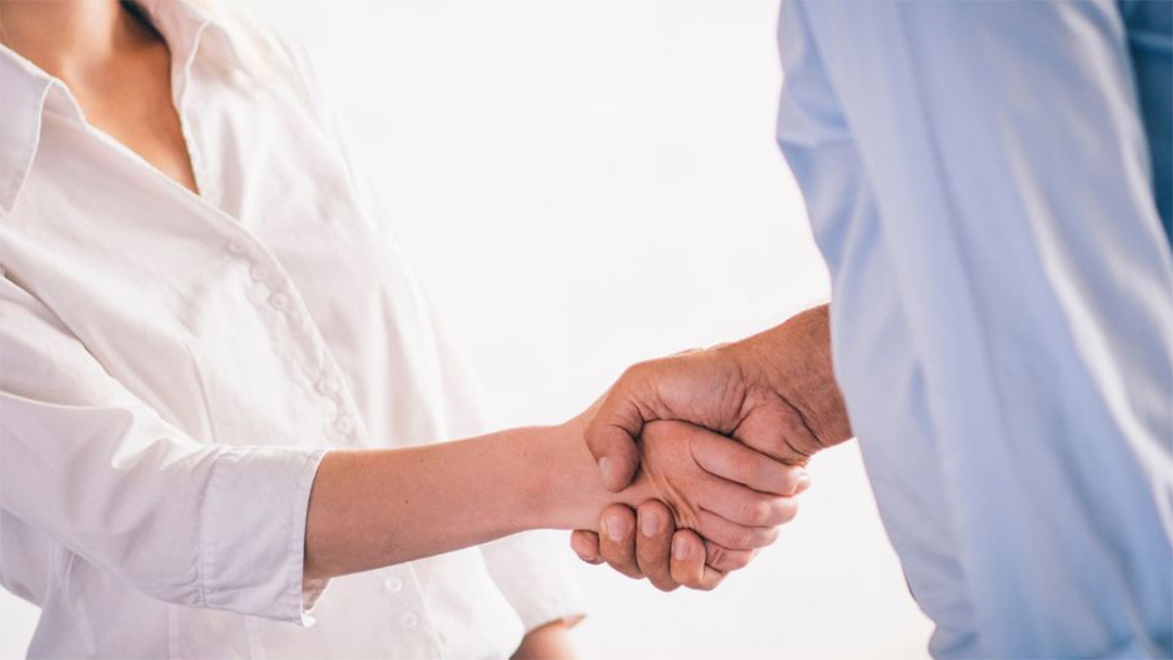 Man and woman shaking hands
