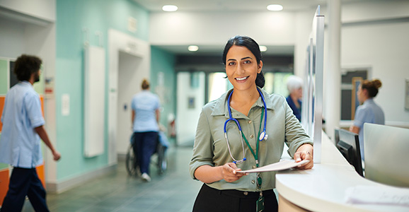 Doctor leaning on reception desk of a medical practice