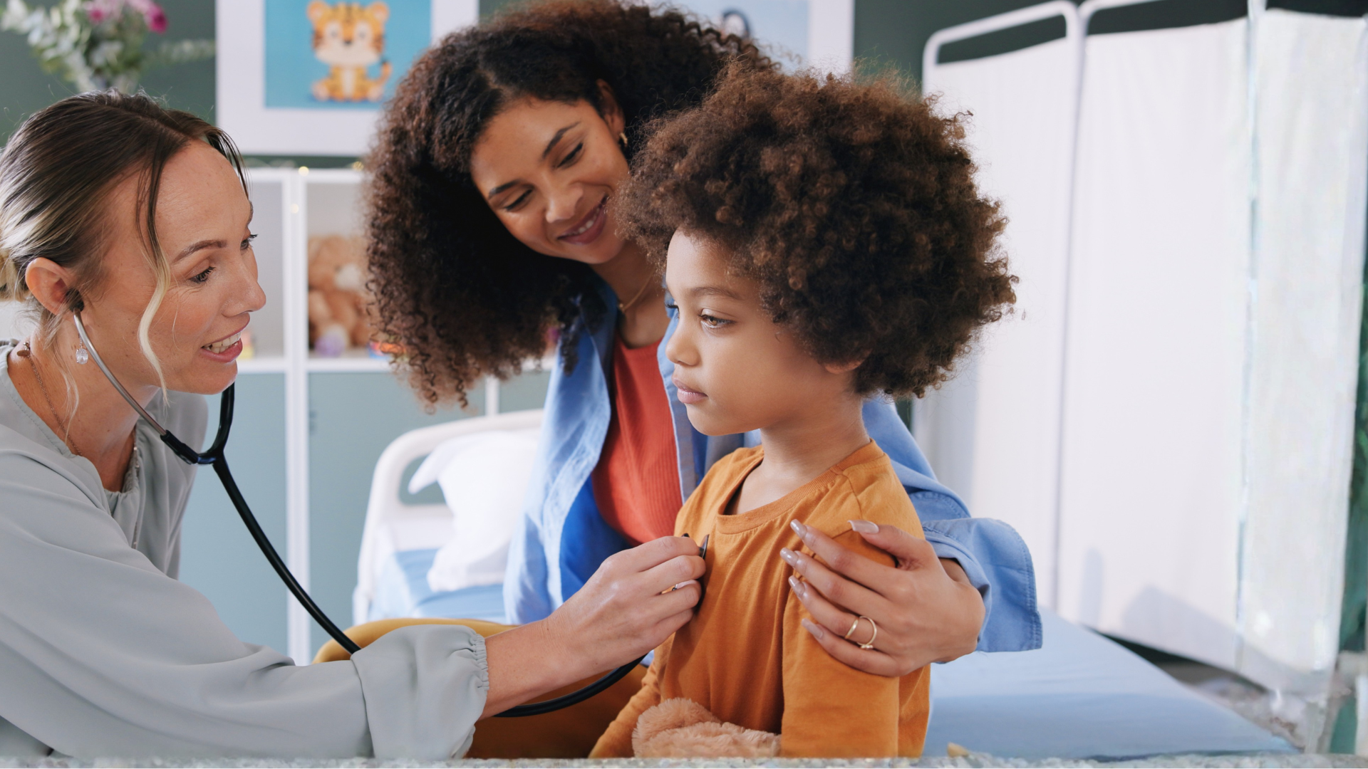 Doctor checking over infant patient in presence of mother